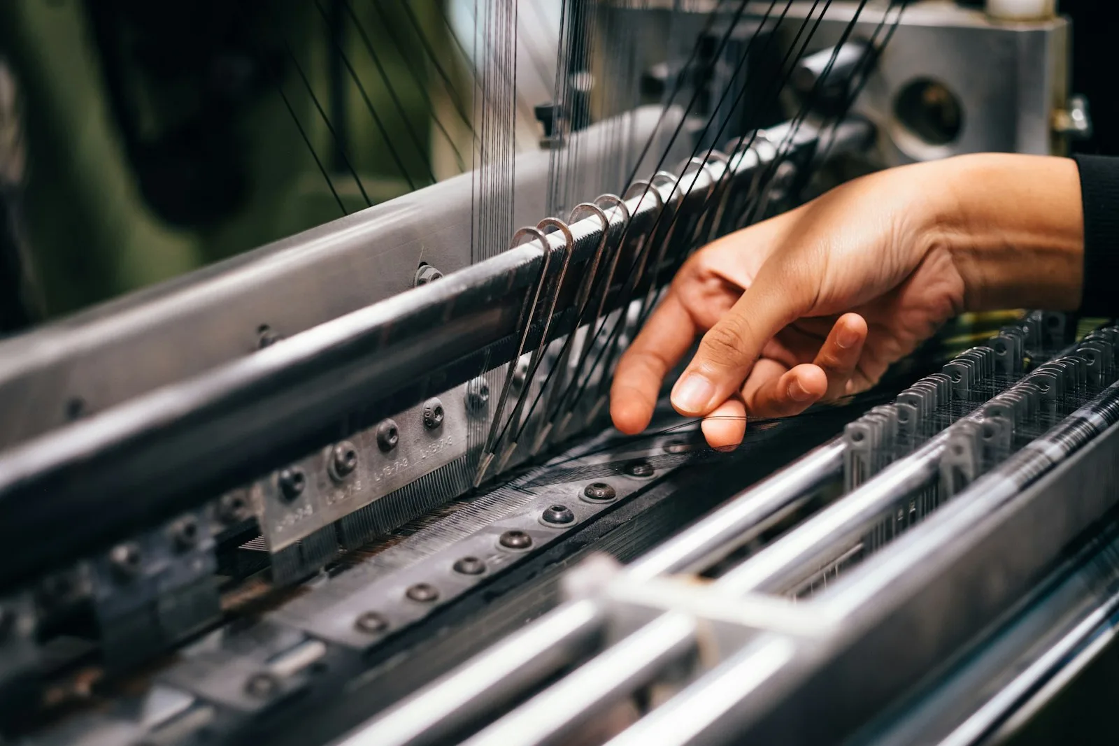 Worker operating a loom at GRC Textile